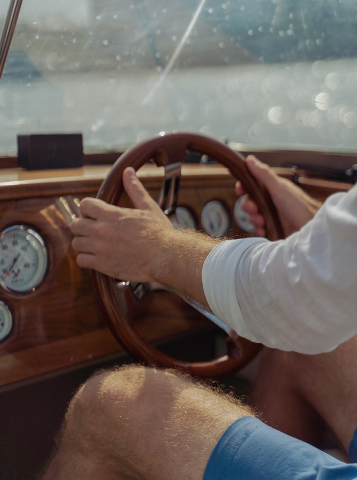 A man piloting a boat on the water